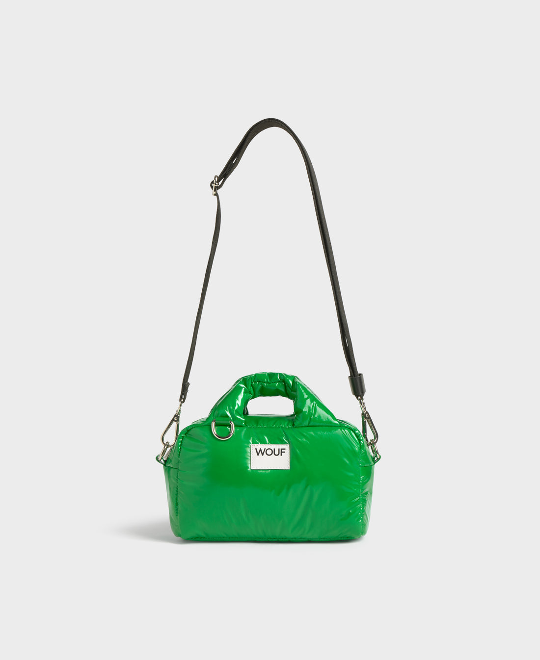 Green handbag with a strap on a white background