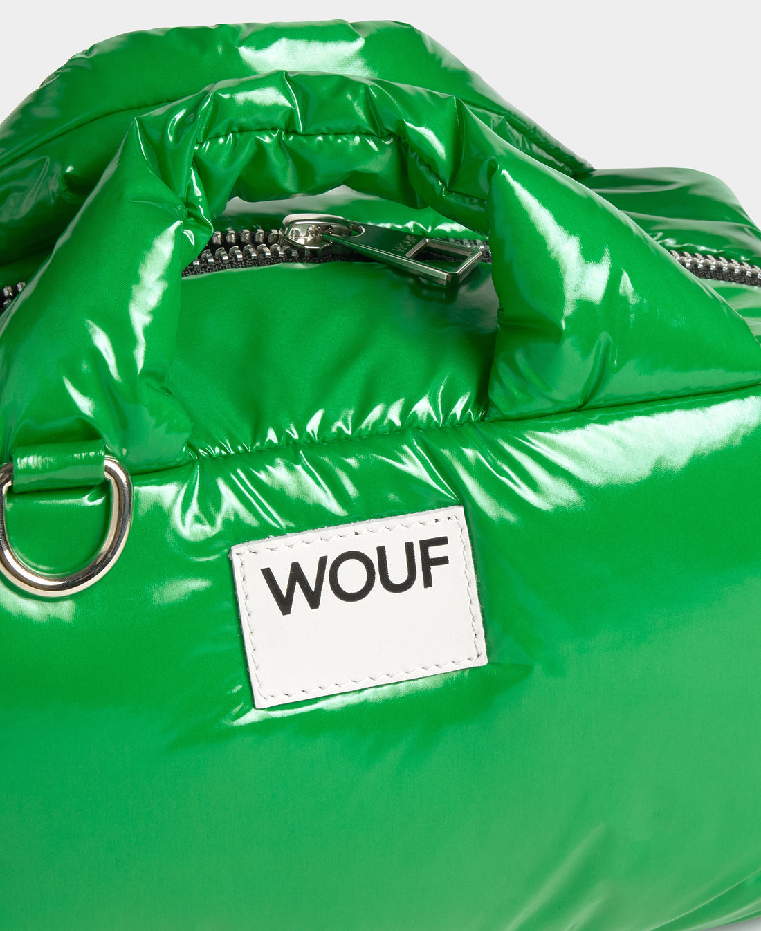 Green glossy bag with a WOUF label on a white background