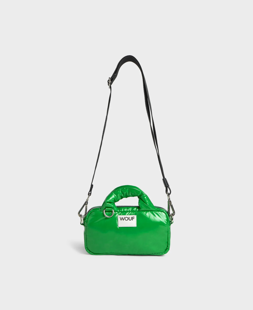 Green handbag with a visible brand logo on a light gray background