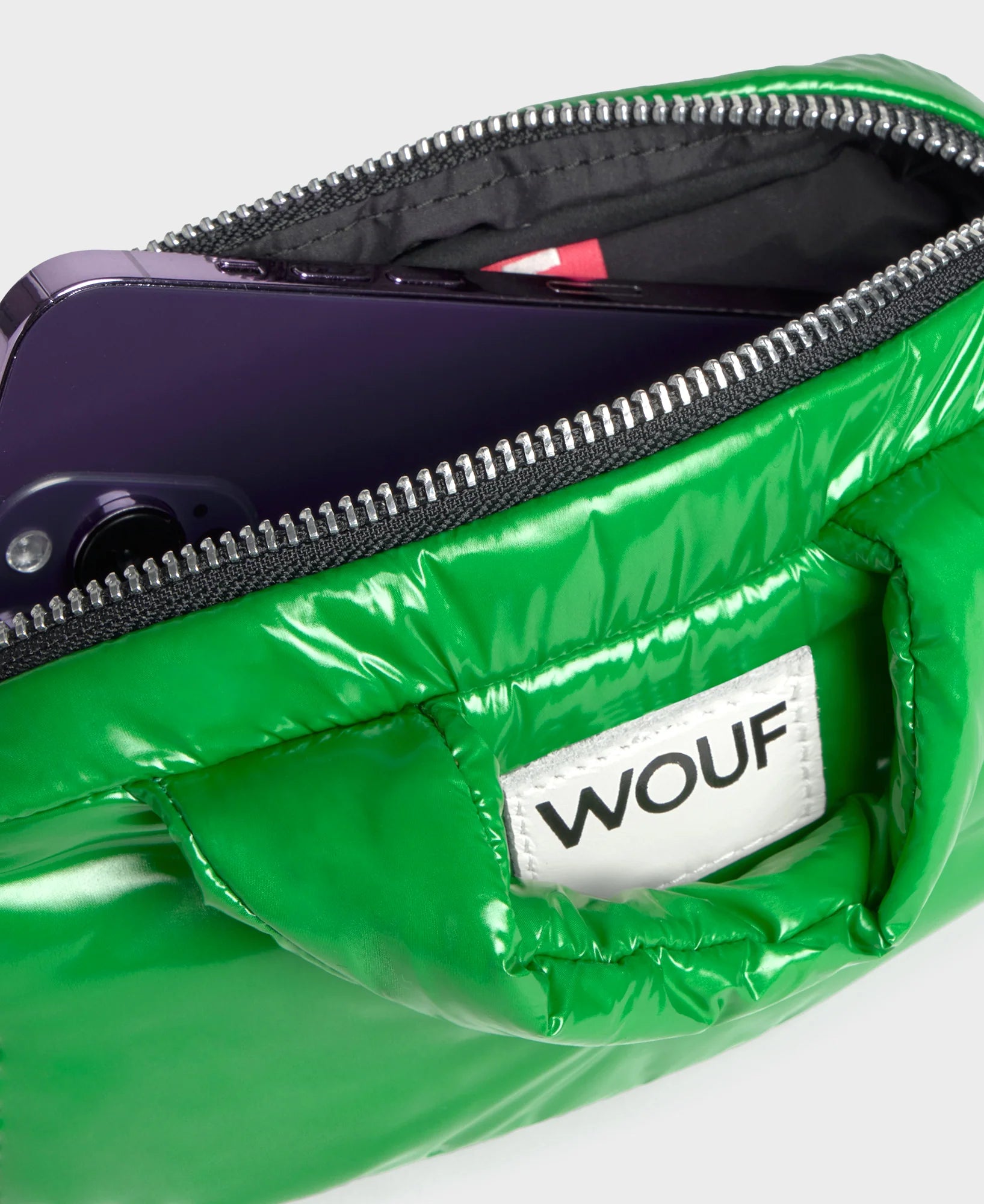 Green puffer bag with a visible 'WOUF' brand logo on a white background