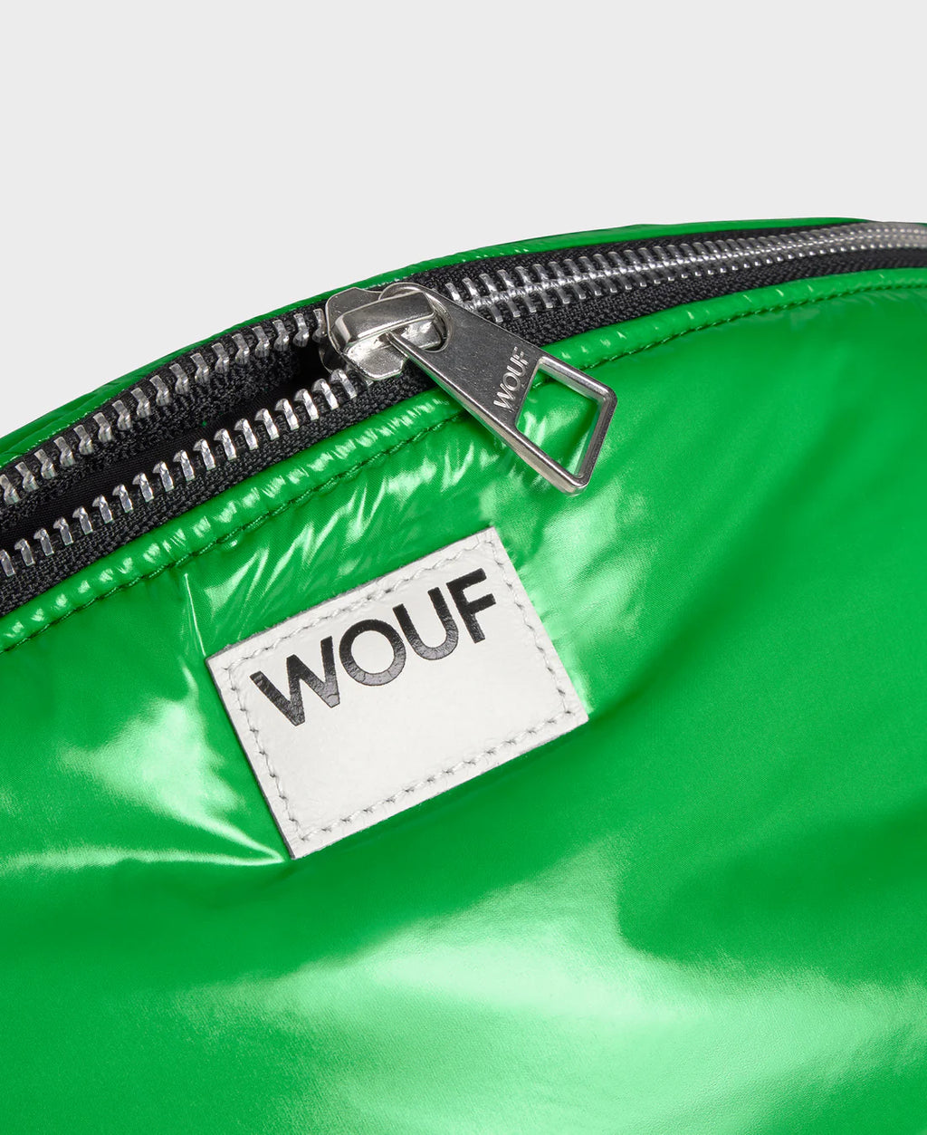 Green bag with a WOUF label on a white background