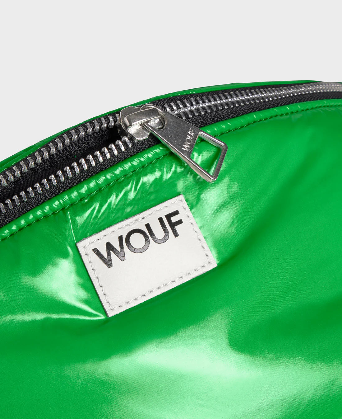 Green bag with a WOUF label on a white background
