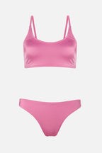Pink bikini set on a light gray background