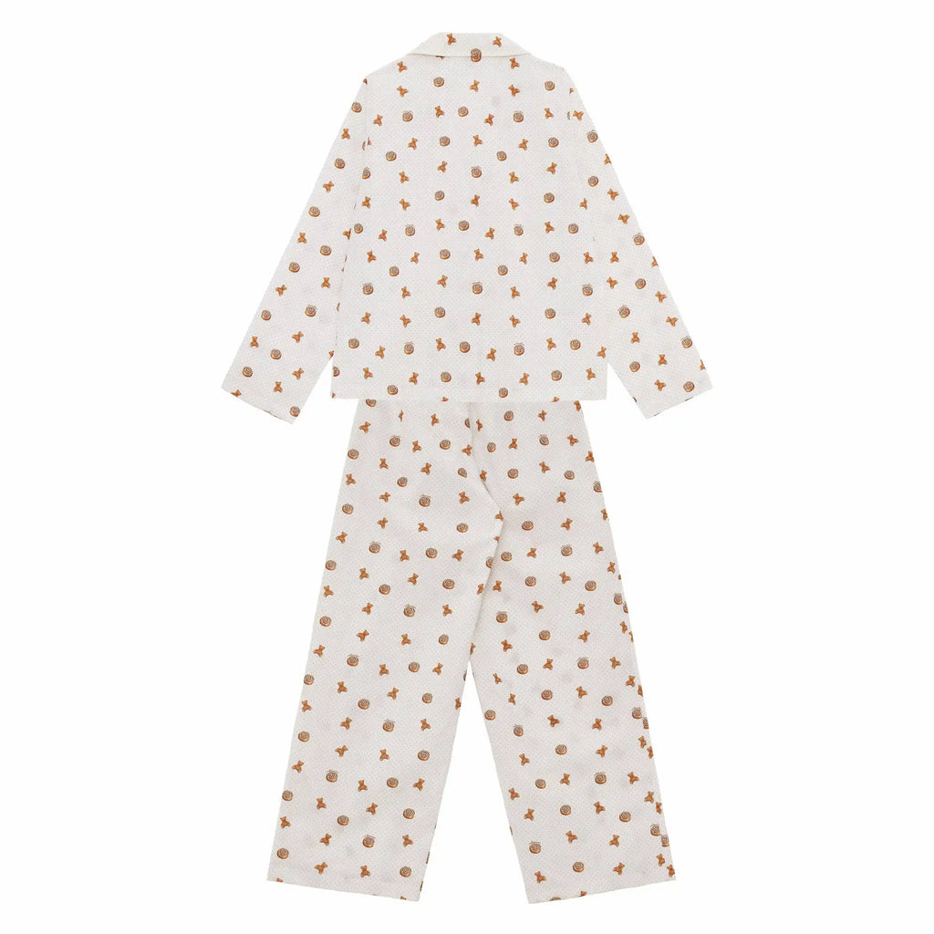 White pajama set with small brown patterns on a white background