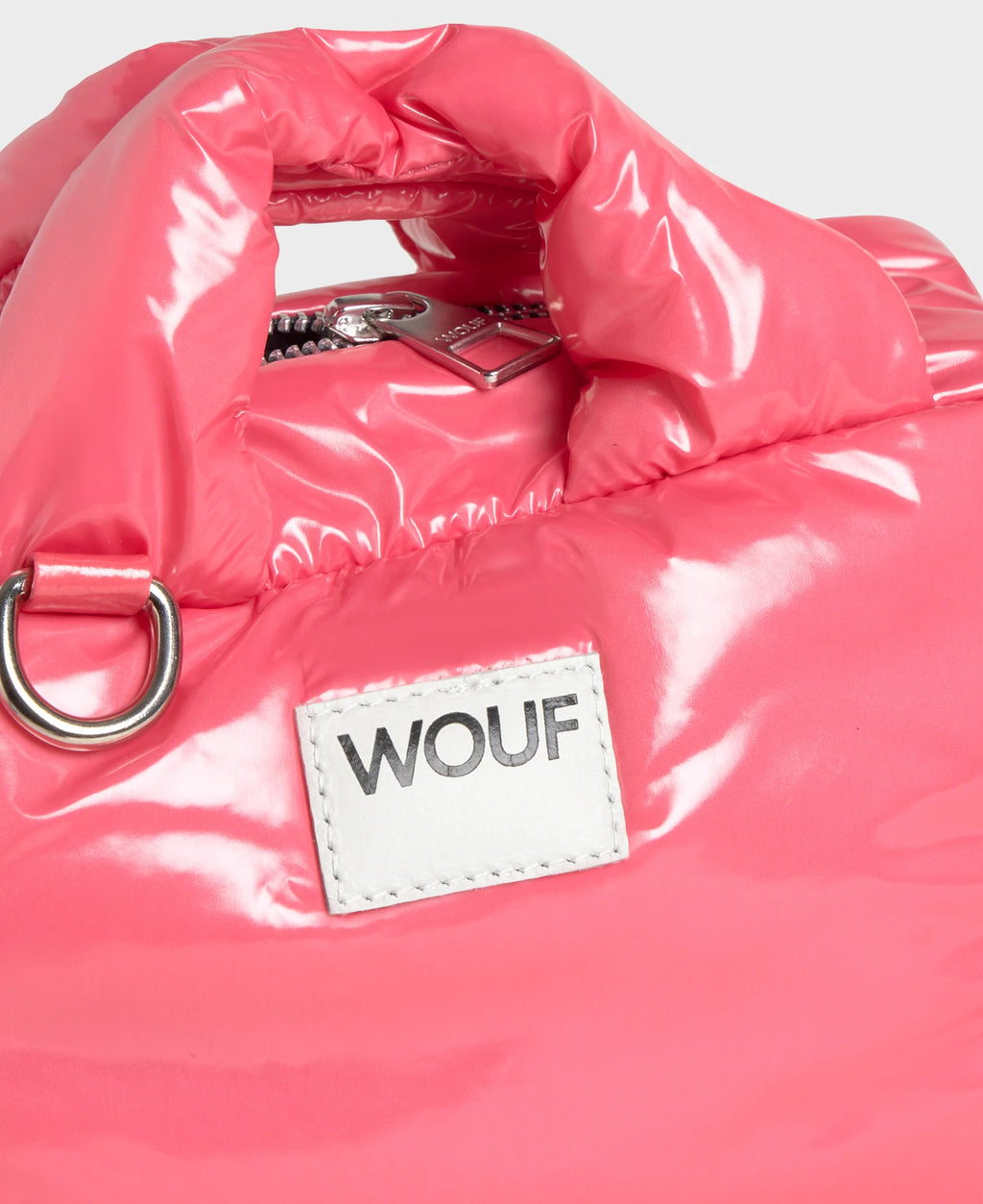Pink puffer jacket with a WOUF label on a white background