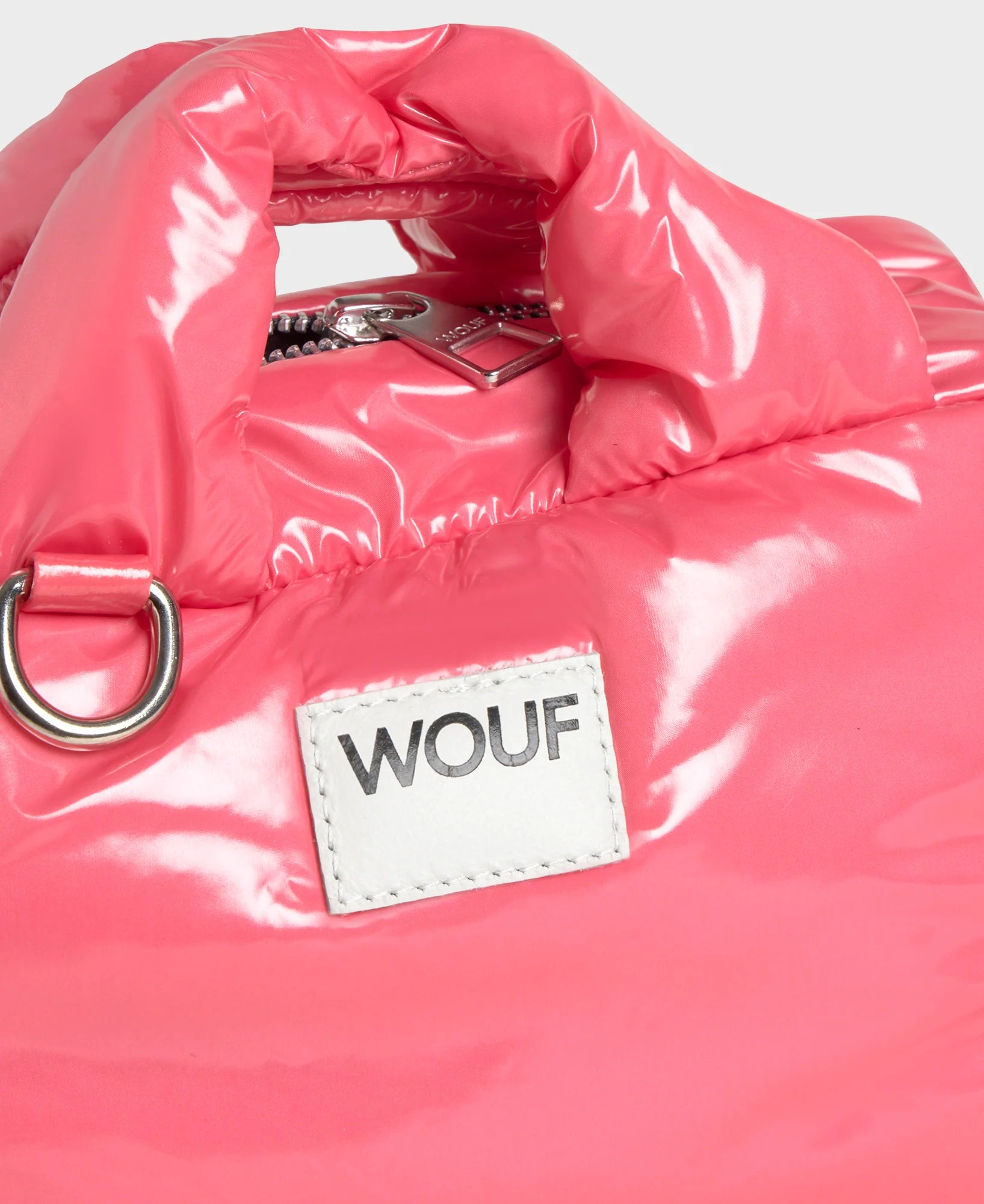 Pink puffer jacket with a WOUF label on a white background
