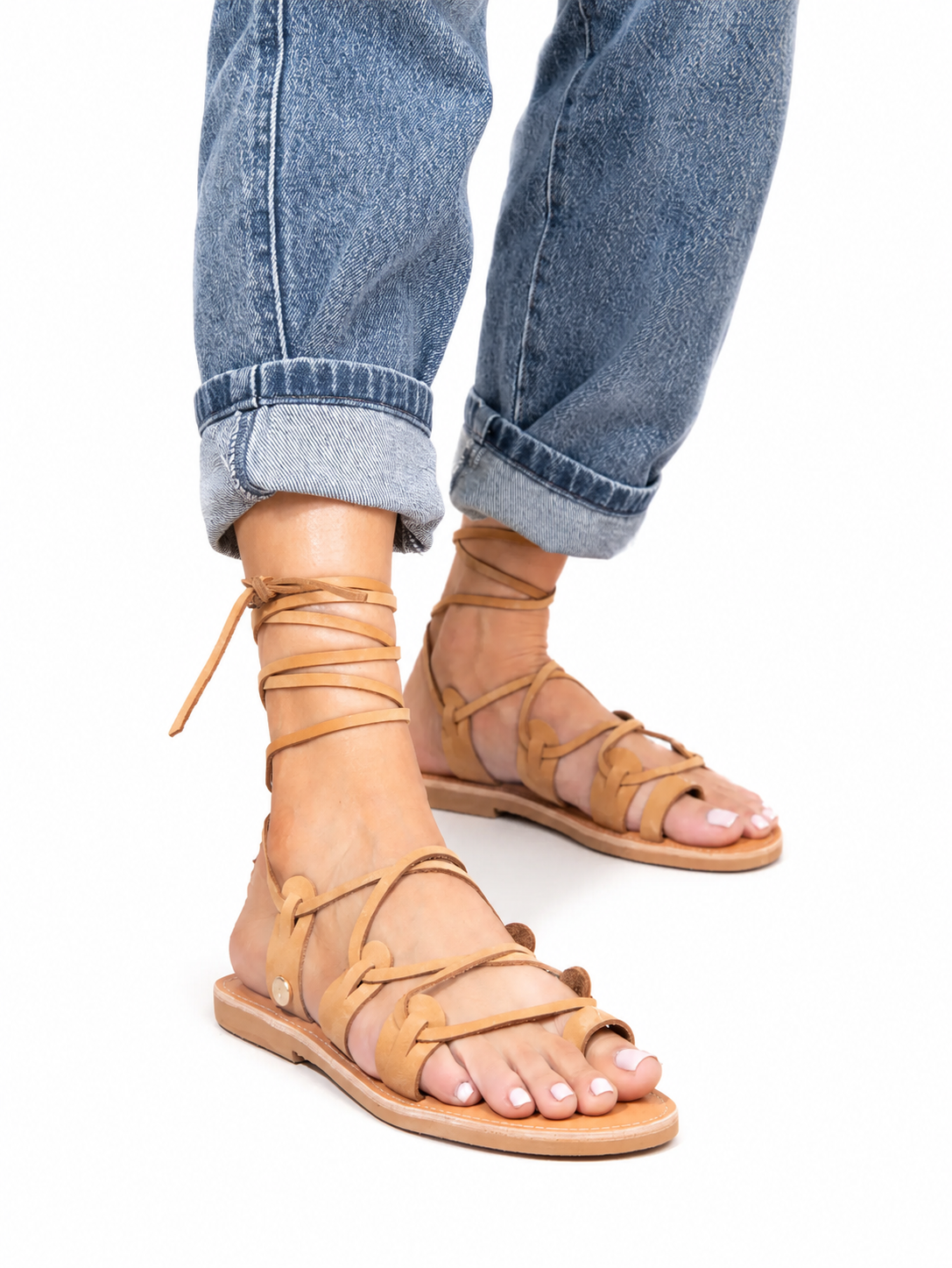 Sandalista Amazona tan leather lace-up sandals with ankle wrap detail worn with cuffed blue jeans side angle