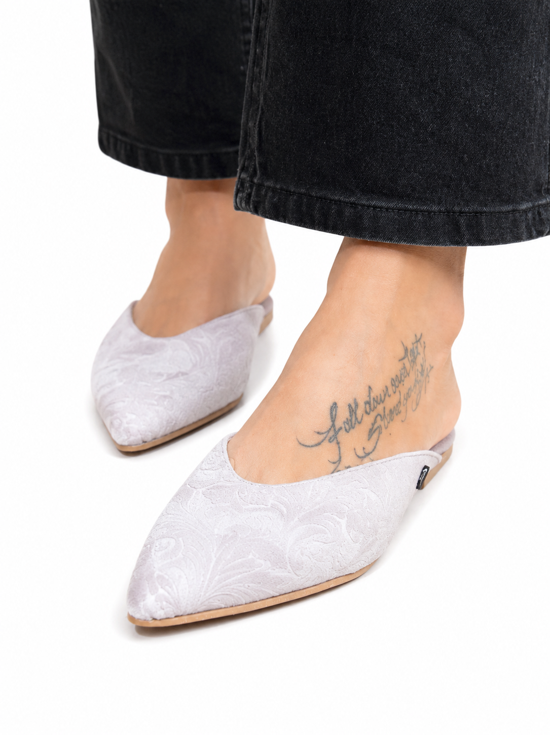 Sandalista Brocade Gray flat leather mules with pointed toe and brocade texture worn with black denim jeans