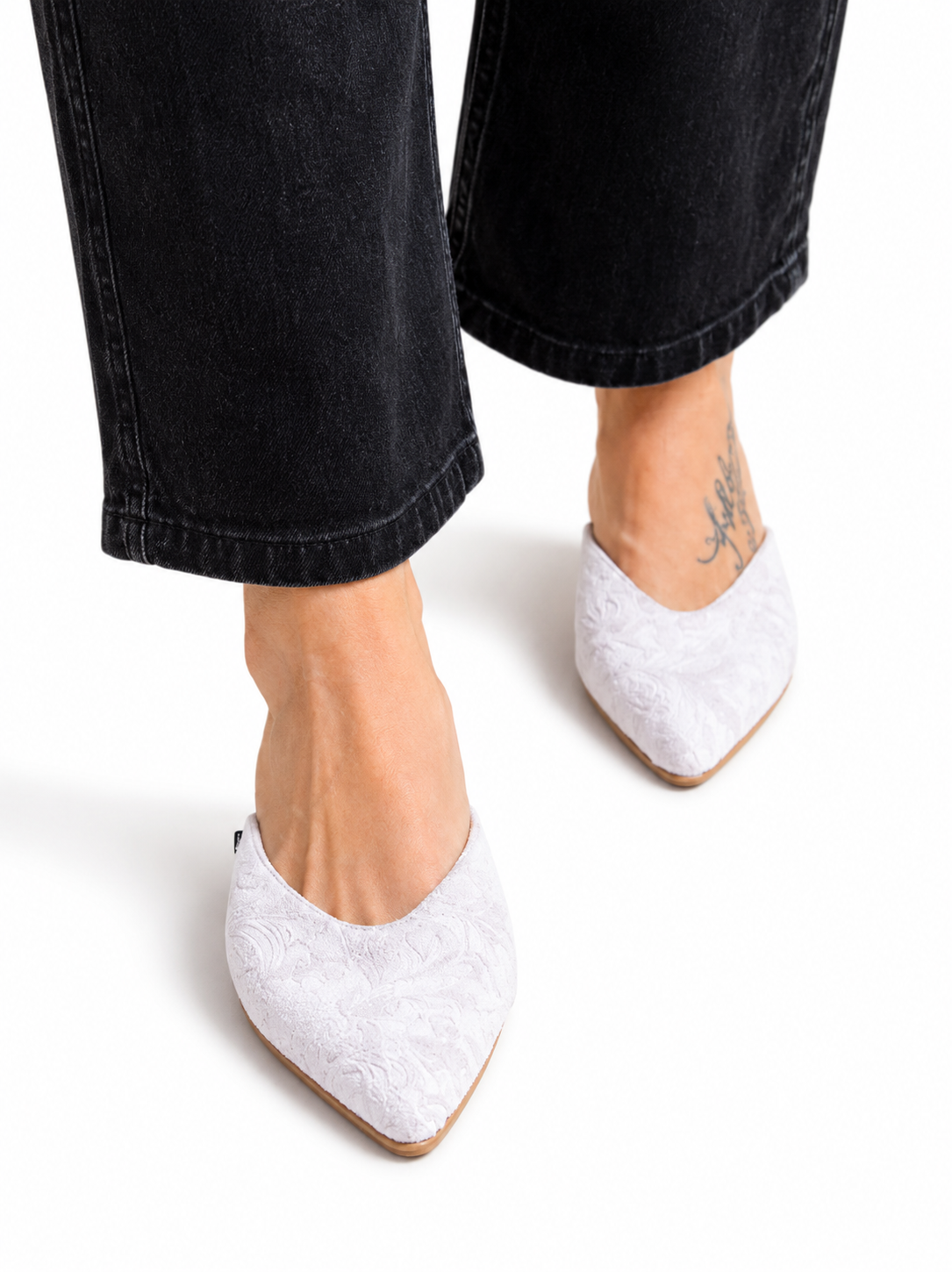 Sandalista Brocade Gray flat leather mules with pointed toe and brocade texture worn with wide-leg black jeans