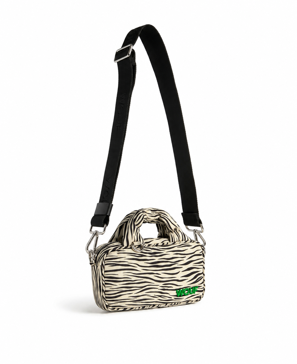 WOUF Zebra Hit Mini Bag in black and white zebra print with green logo embroidery and wide black strap side angle view