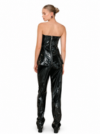 A model shown from the back wearing a glossy black strapless corset top and matching high-waisted patent pants against a plain white background.