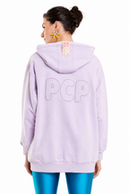 A model shown from the back wearing a lavender purple hoodie with 'PCP' embroidered in large letters on the back, paired with metallic blue leggings against a white background.
