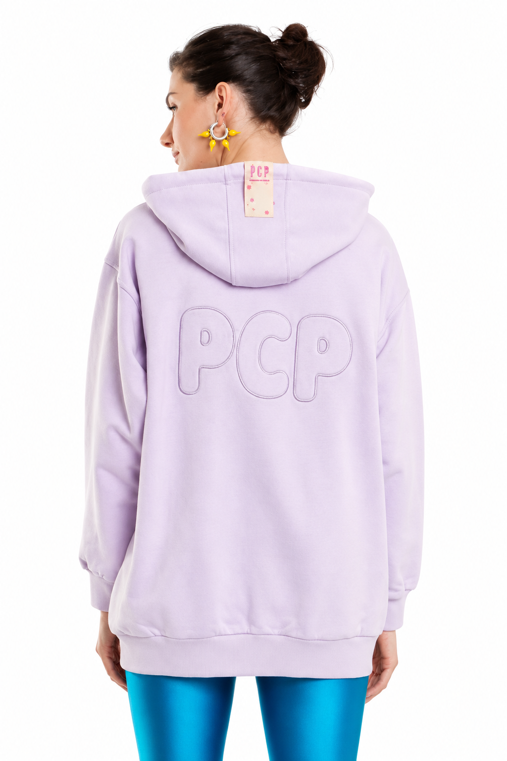 A model shown from the back wearing a lavender purple hoodie with 'PCP' embroidered in large letters on the back, paired with metallic blue leggings against a white background.