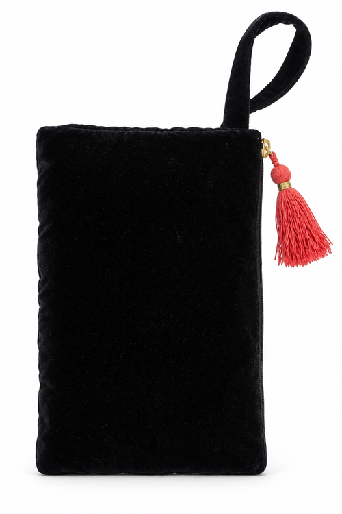 A black velvet clutch bag with a top handle and a red tassel zipper pull, shown against a plain white background.