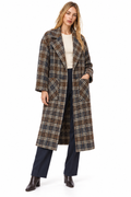 A woman modeling a long plaid coat over a cream top, navy wide-leg pants, and dark brown ankle boots, photographed against a plain white studio background.