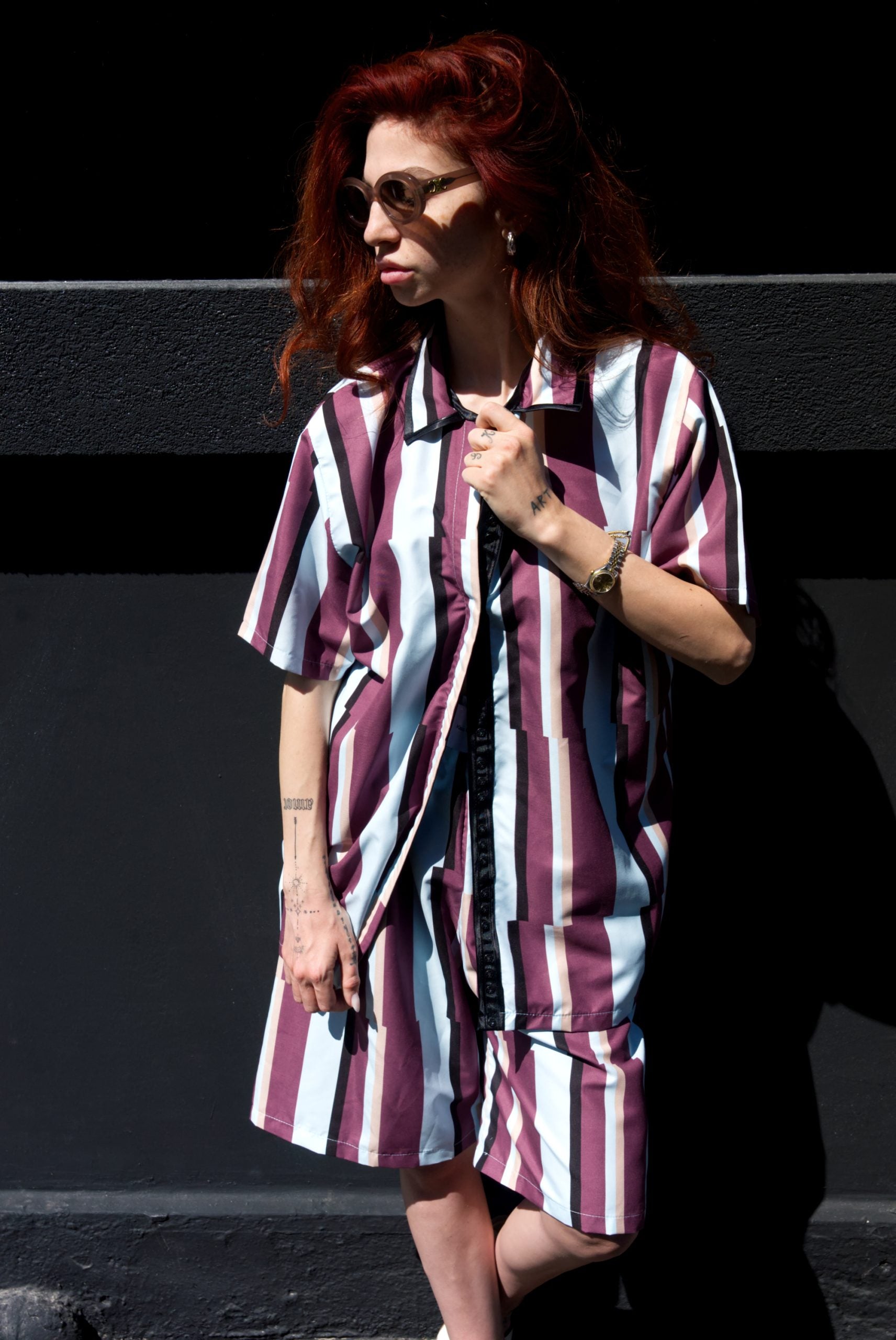 Person wearing a striped dress with a black and white background