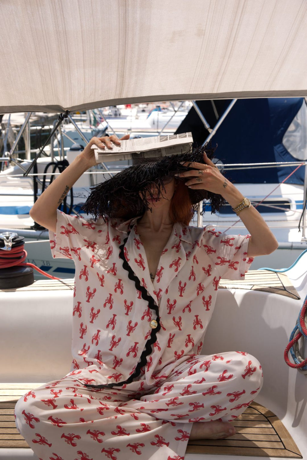 Person wearing a red and white patterned outfit on a boat
