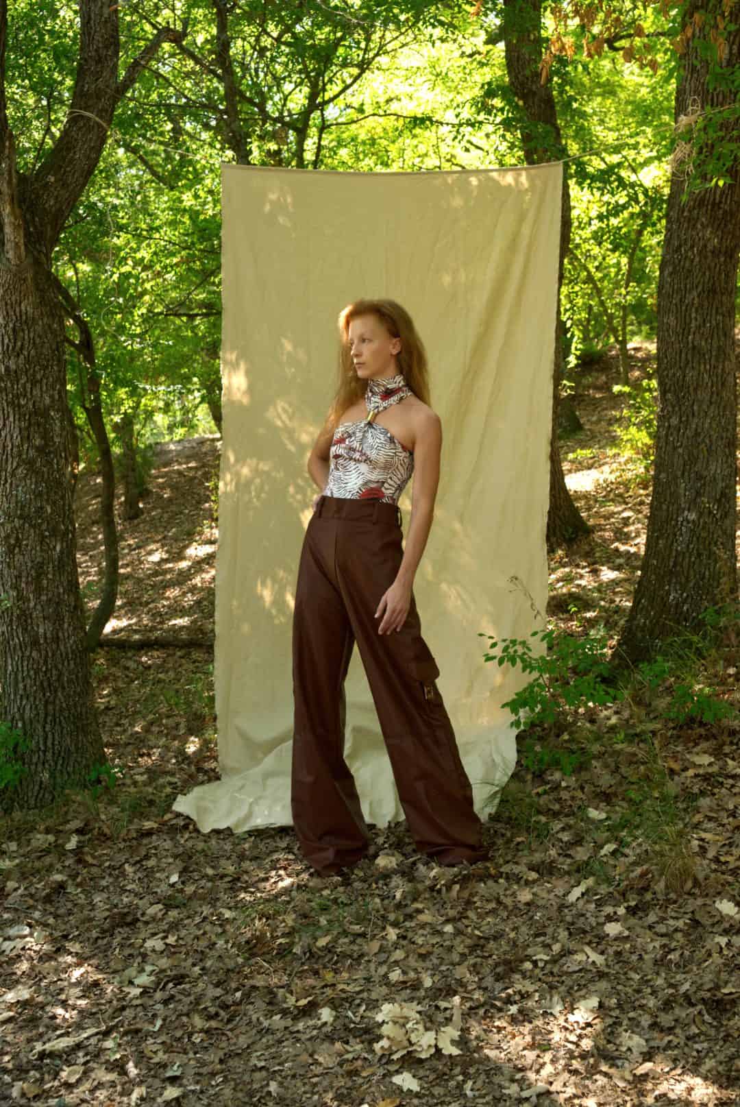 Woman standing in a forest with a white backdrop