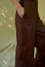 Brown cargo pants worn by a person against a neutral background