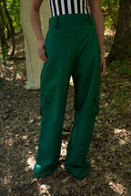 Person wearing green pants standing in a forest setting