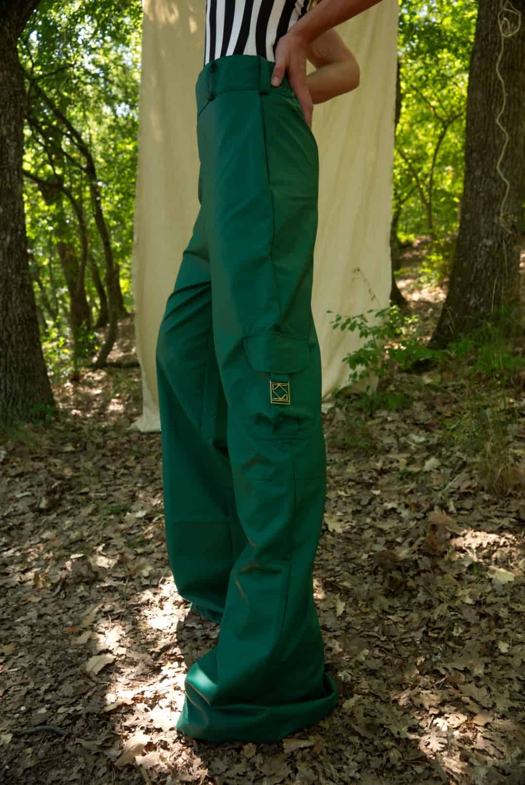 Person wearing green pants standing in a forest setting