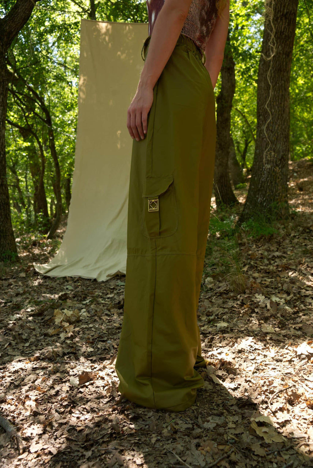 Person wearing green pants standing in a forest