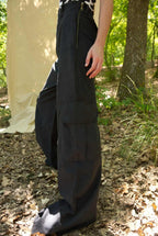 Person wearing a long black skirt in a forest setting