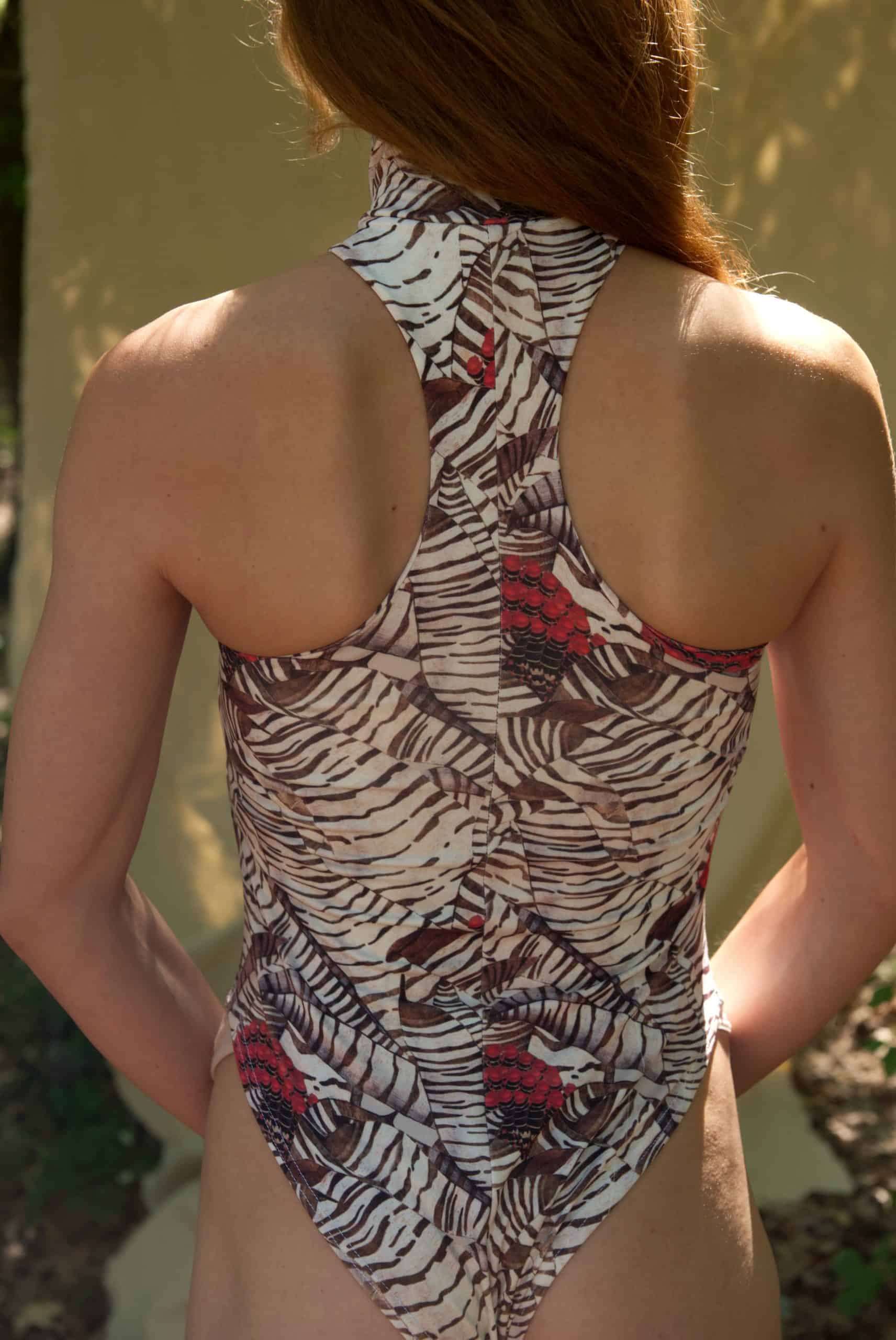 Person wearing a patterned swimsuit with a neutral background