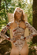 Person wearing a patterned outfit in a forest setting