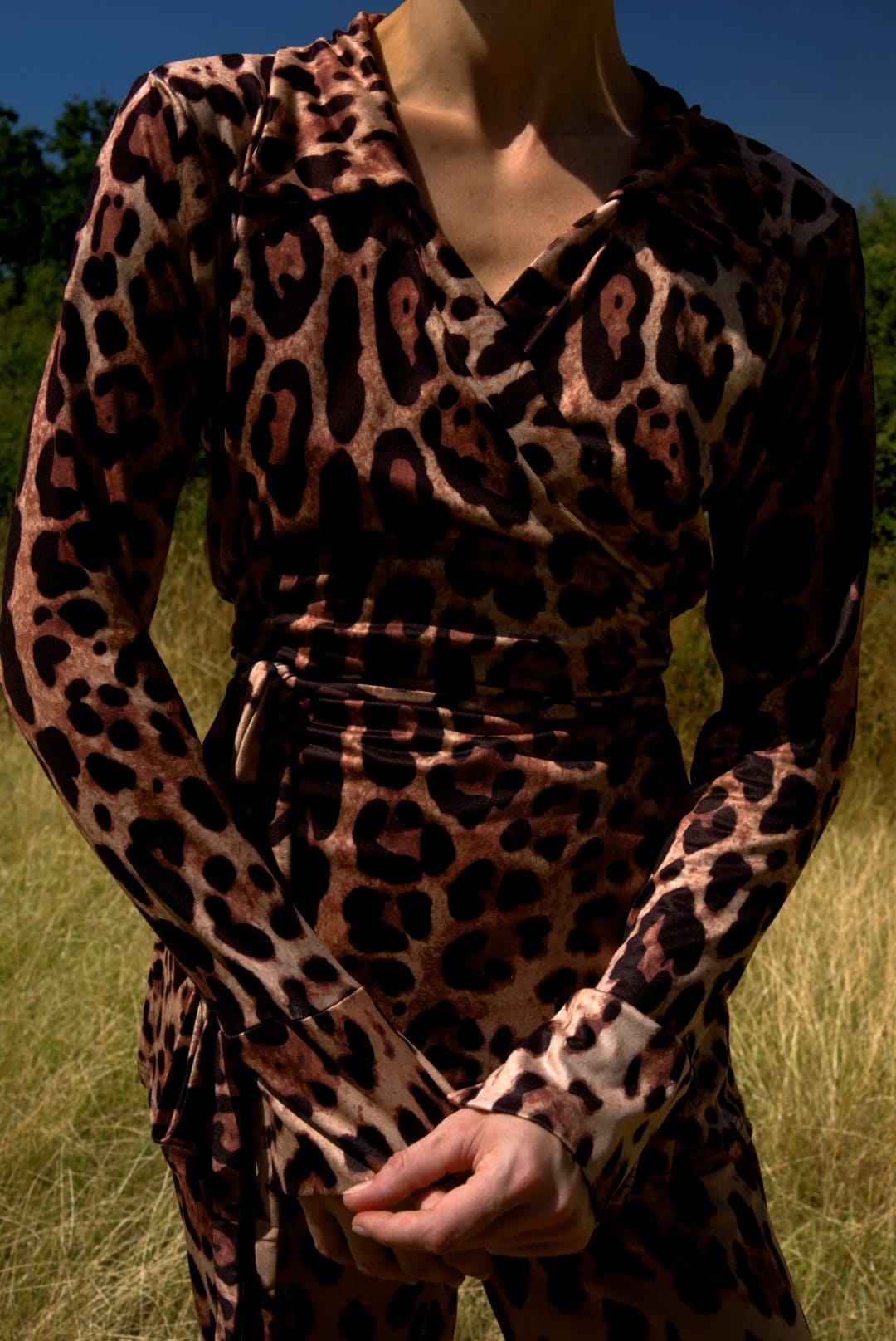 Leopard print dress on a mannequin against a natural background
