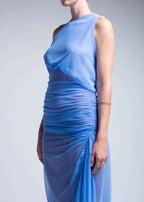Blue evening gown with a draped design on a plain background