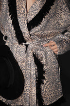 Knitted leopard print jacket with black fringes.