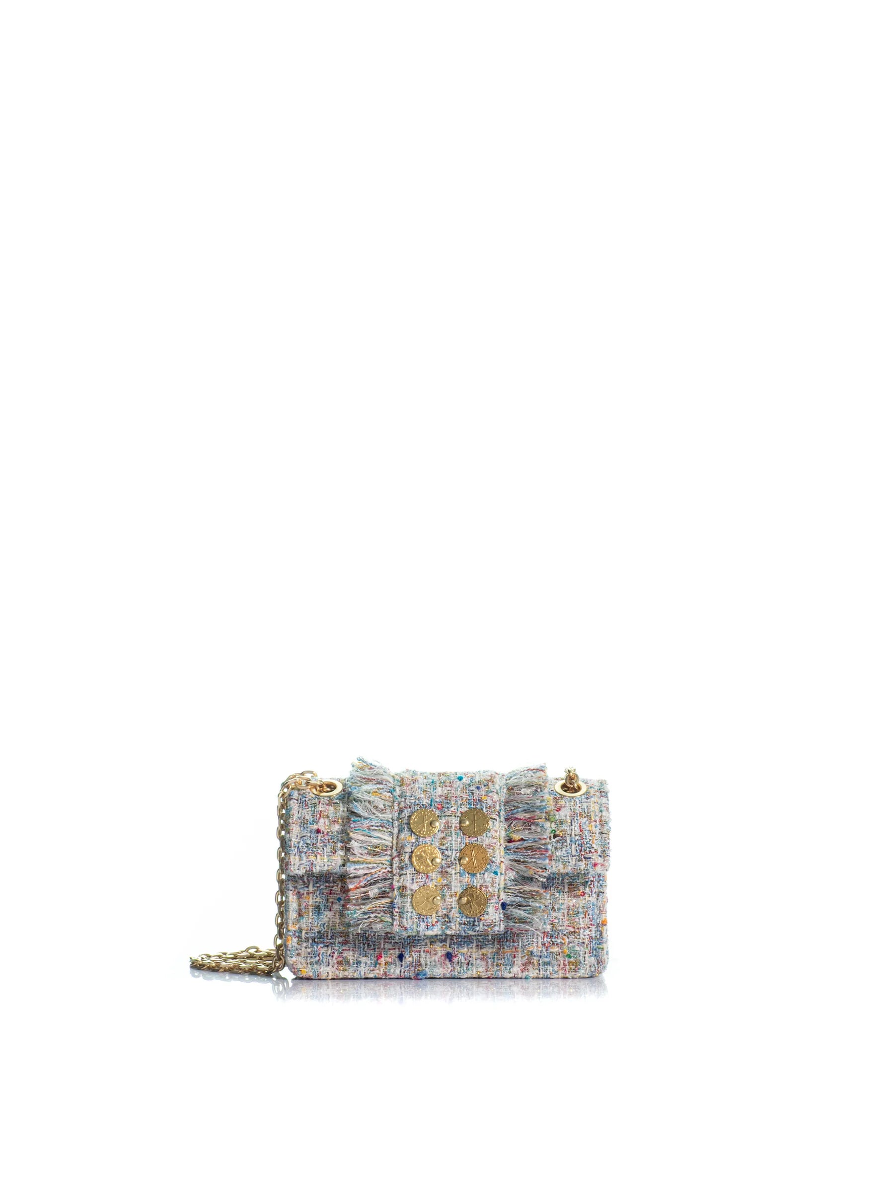 Multicolored textured handbag with gold accents on a white background