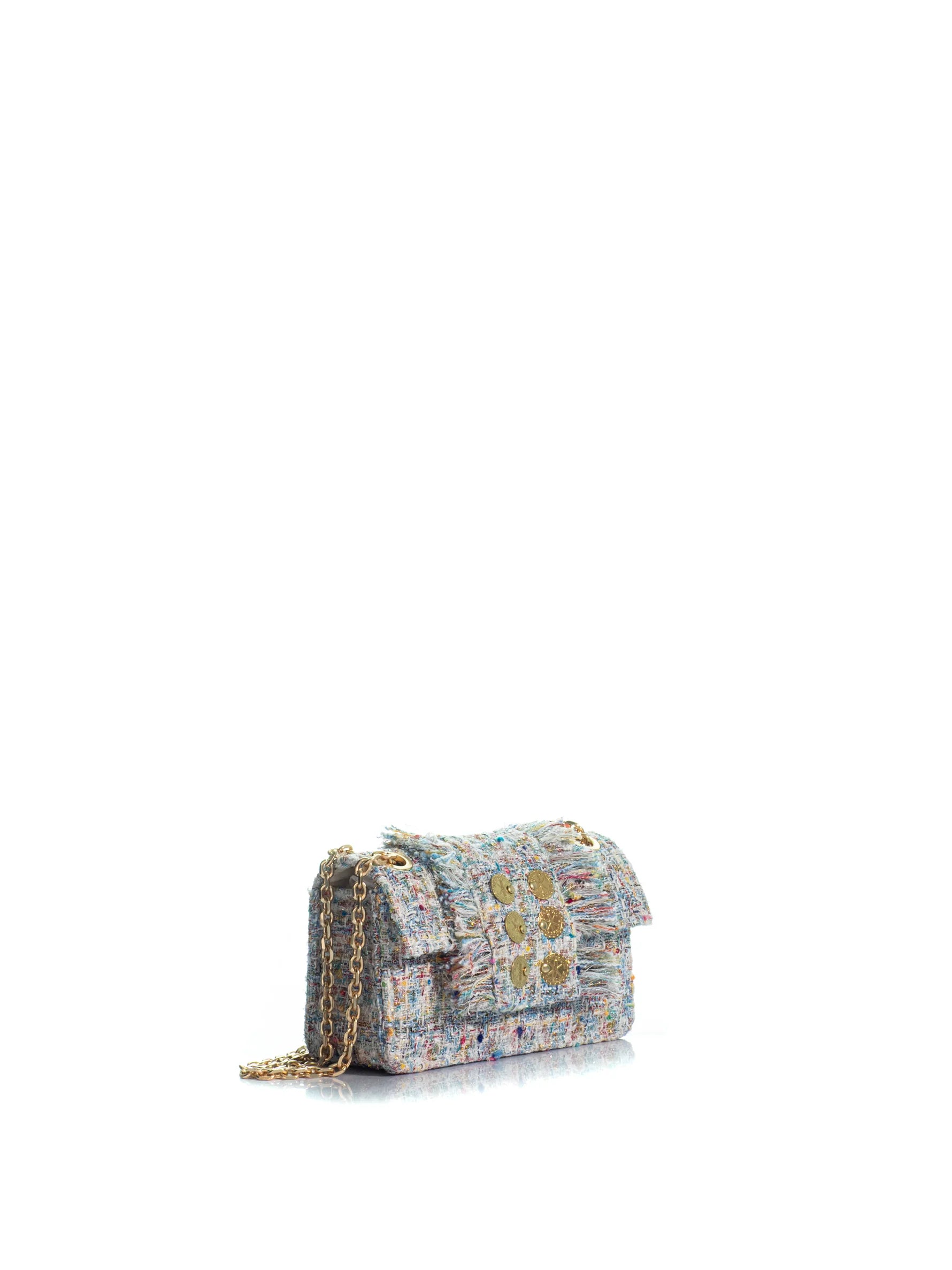 Multicolored patterned handbag with a chain strap on a white background