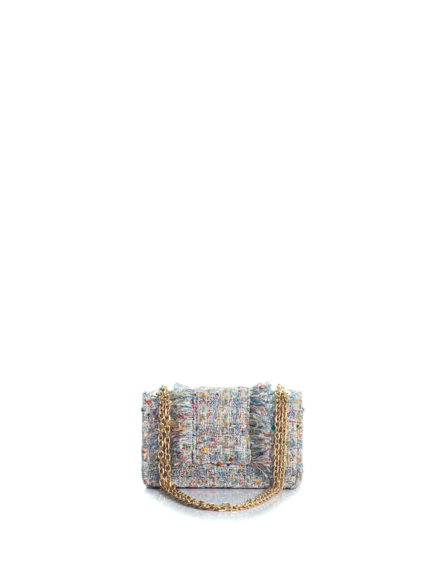 Multicolored tweed handbag with a gold chain on a white background