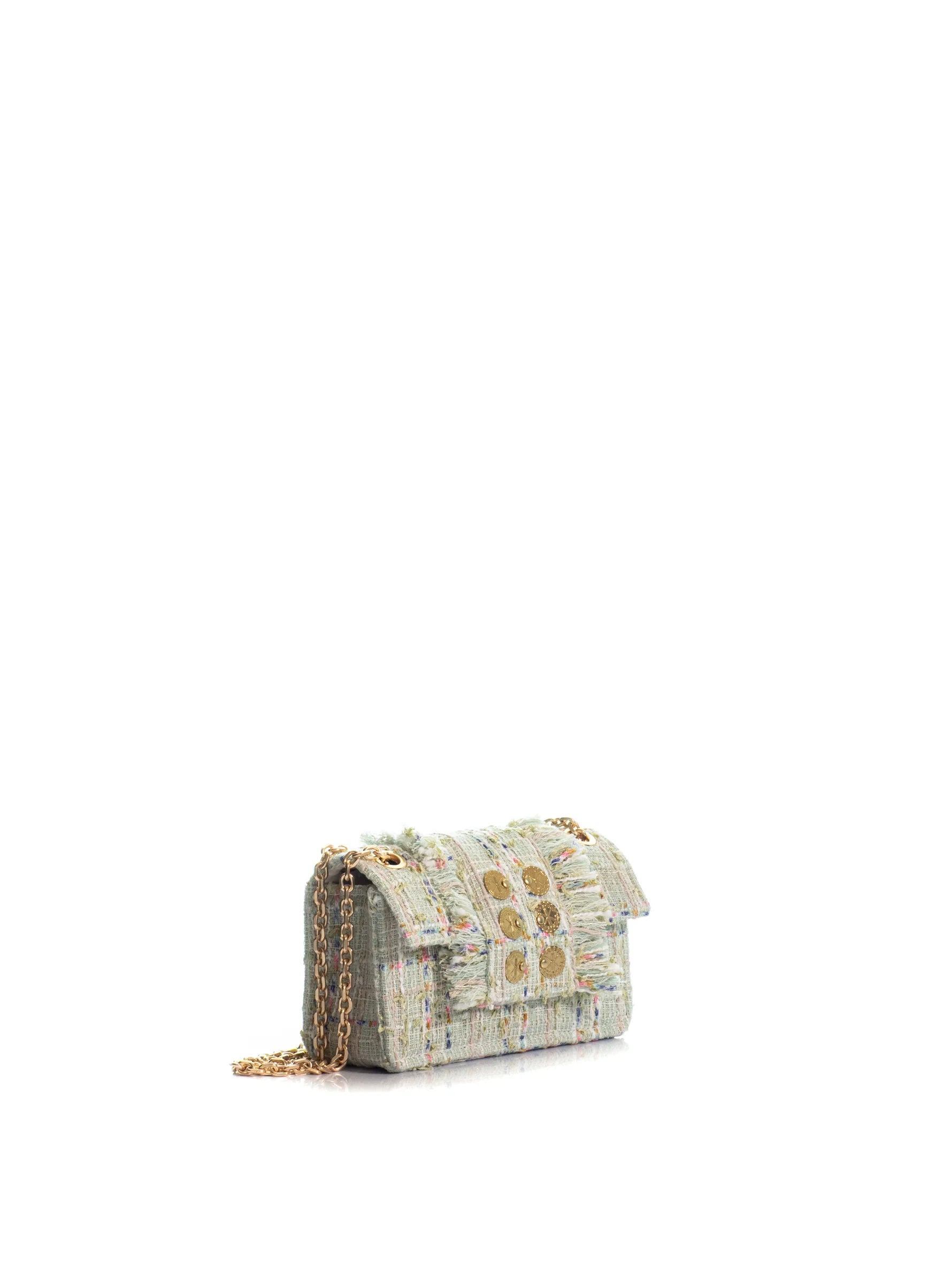 Designer handbag with gold chain on a white background