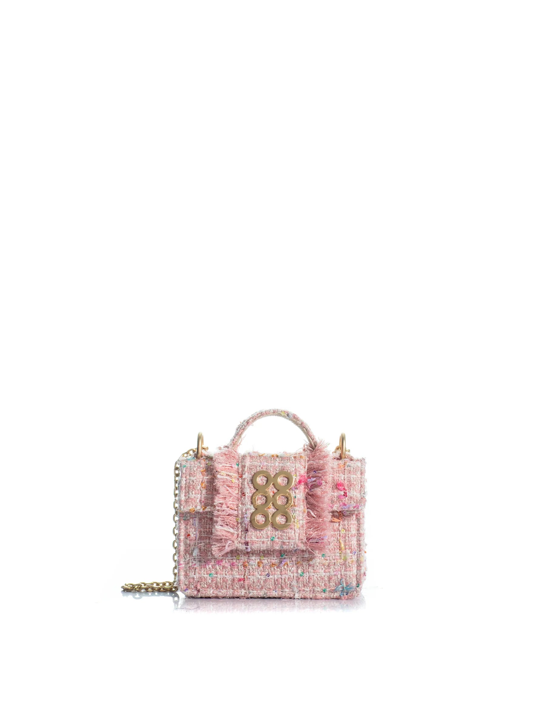 Pink textured handbag with decorative elements on a white background