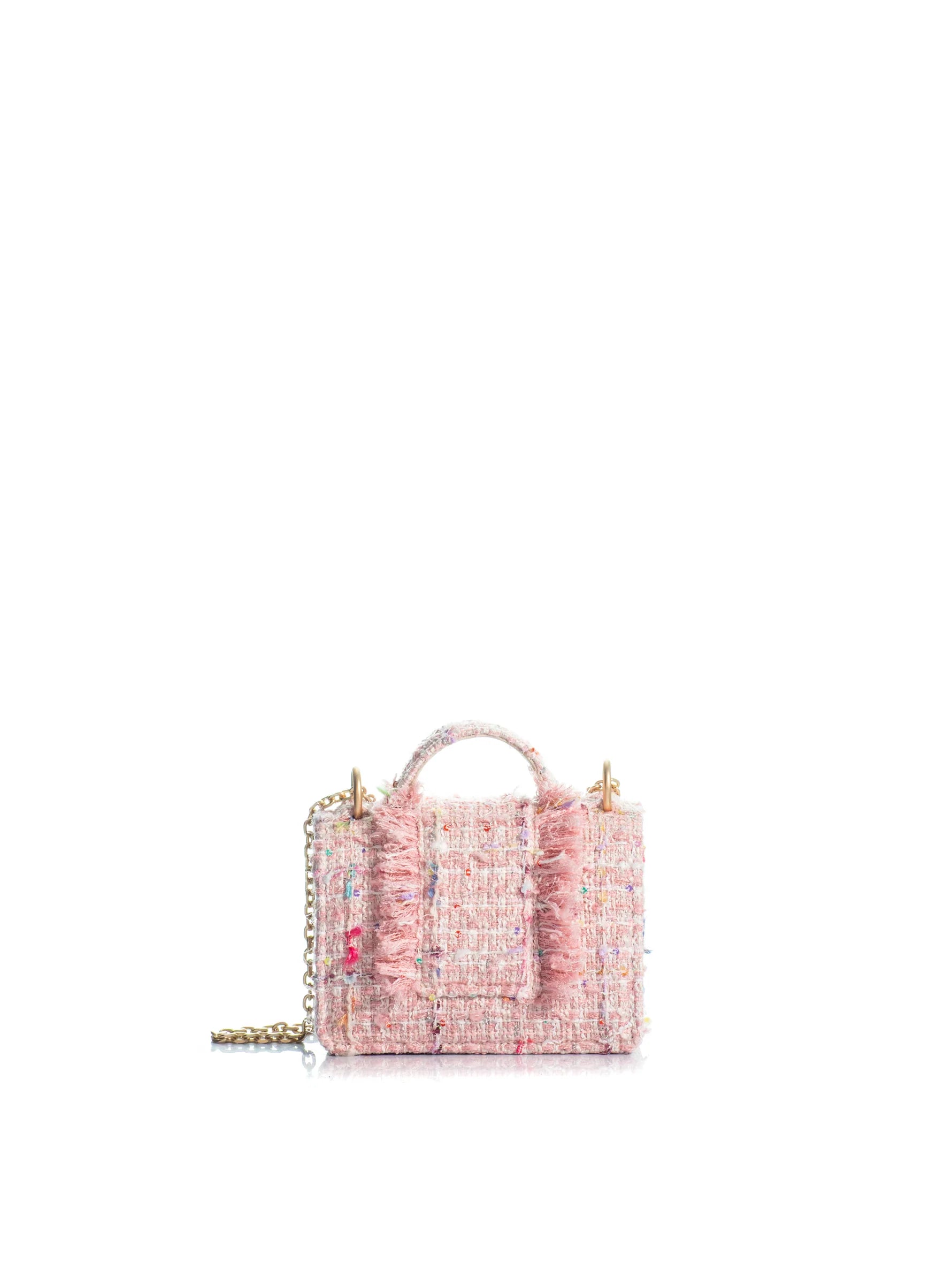 Pink textured handbag with gold accents on a white background