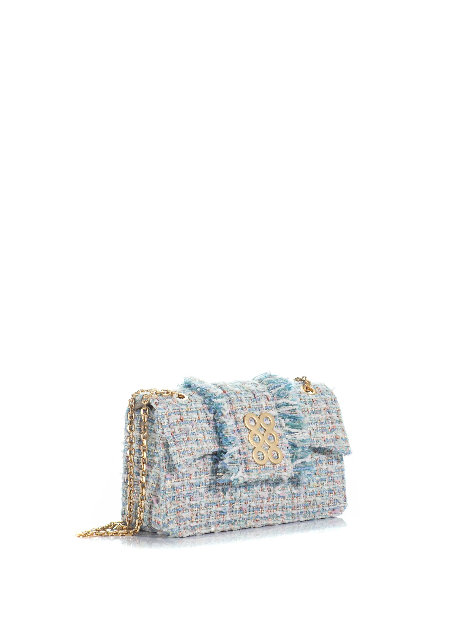 Tweed handbag with gold chain on a white background