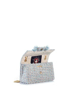 Designer handbag with decorative elements on a white background