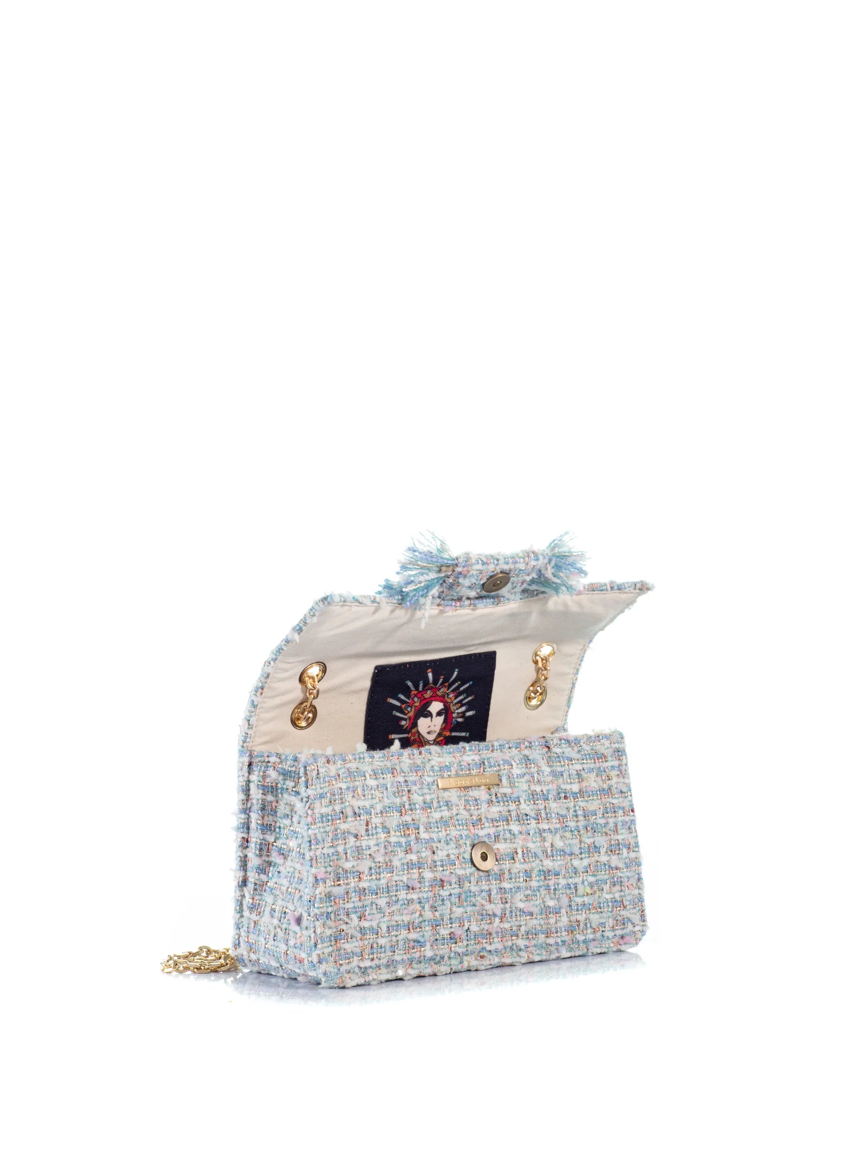 Designer handbag with decorative elements on a white background