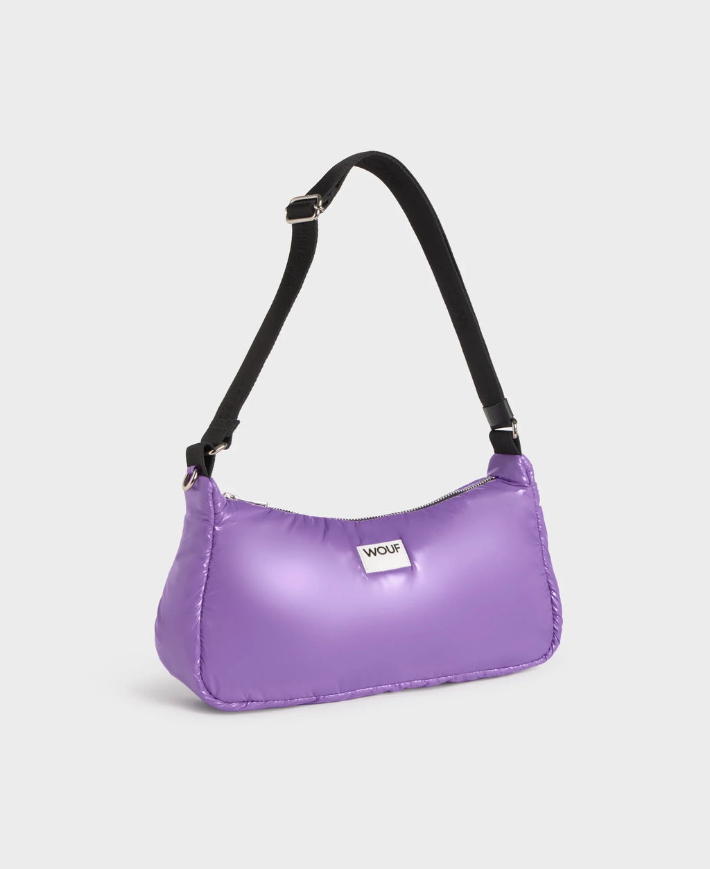 Purple handbag with a black strap on a light gray background