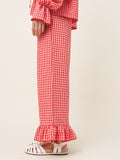 Red and white checkered dress with ruffled details on a plain background