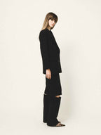 Person wearing a black outfit on a white background