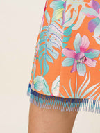 Tropical floral skirt with fringes on a beige background