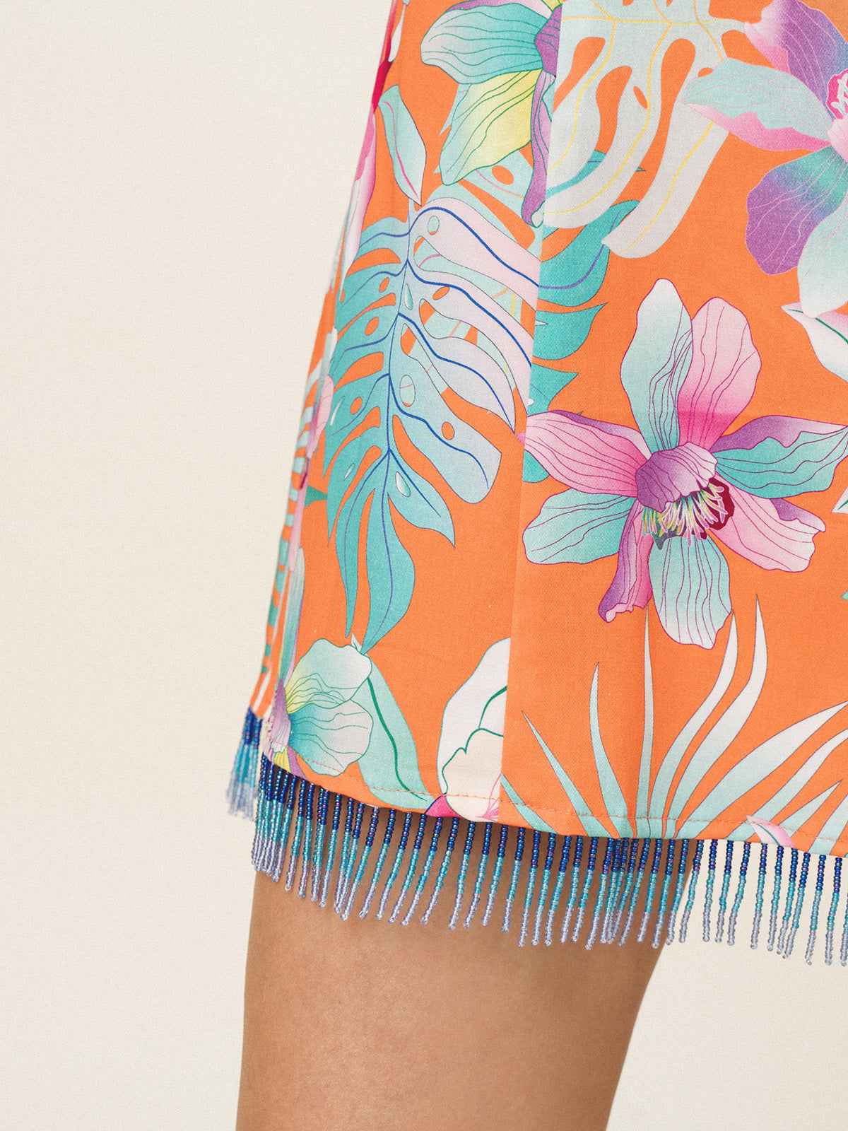 Tropical floral skirt with fringes on a beige background