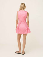 Woman wearing a pink dress on a white background