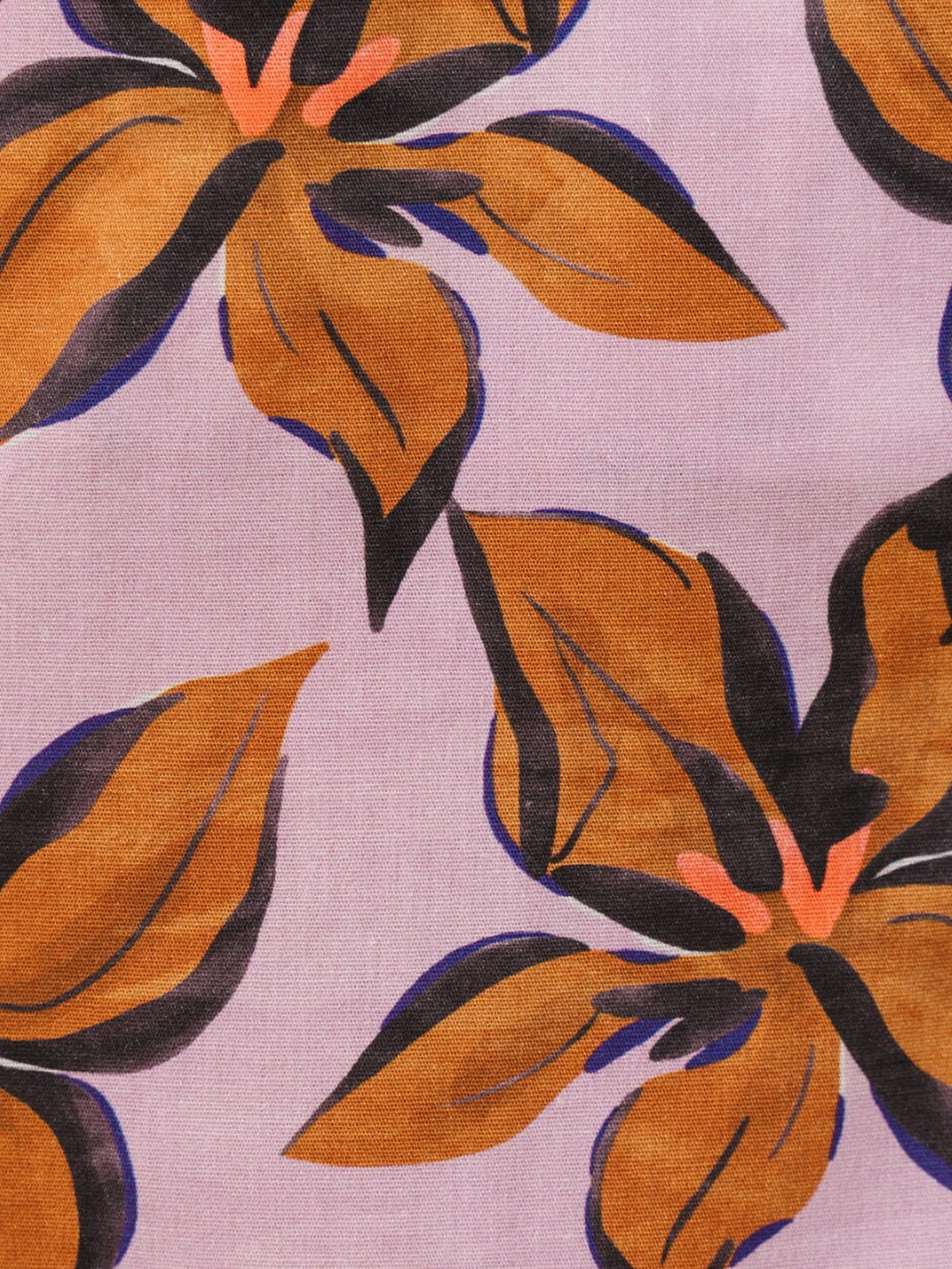 A close-up of a floral fabric pattern featuring large orange-brown flowers with dark navy and black outlines on a light lavender background.