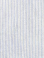 Textile pattern with blue and white vertical stripes on a textured background