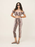 Woman wearing a leopard print outfit on a white background